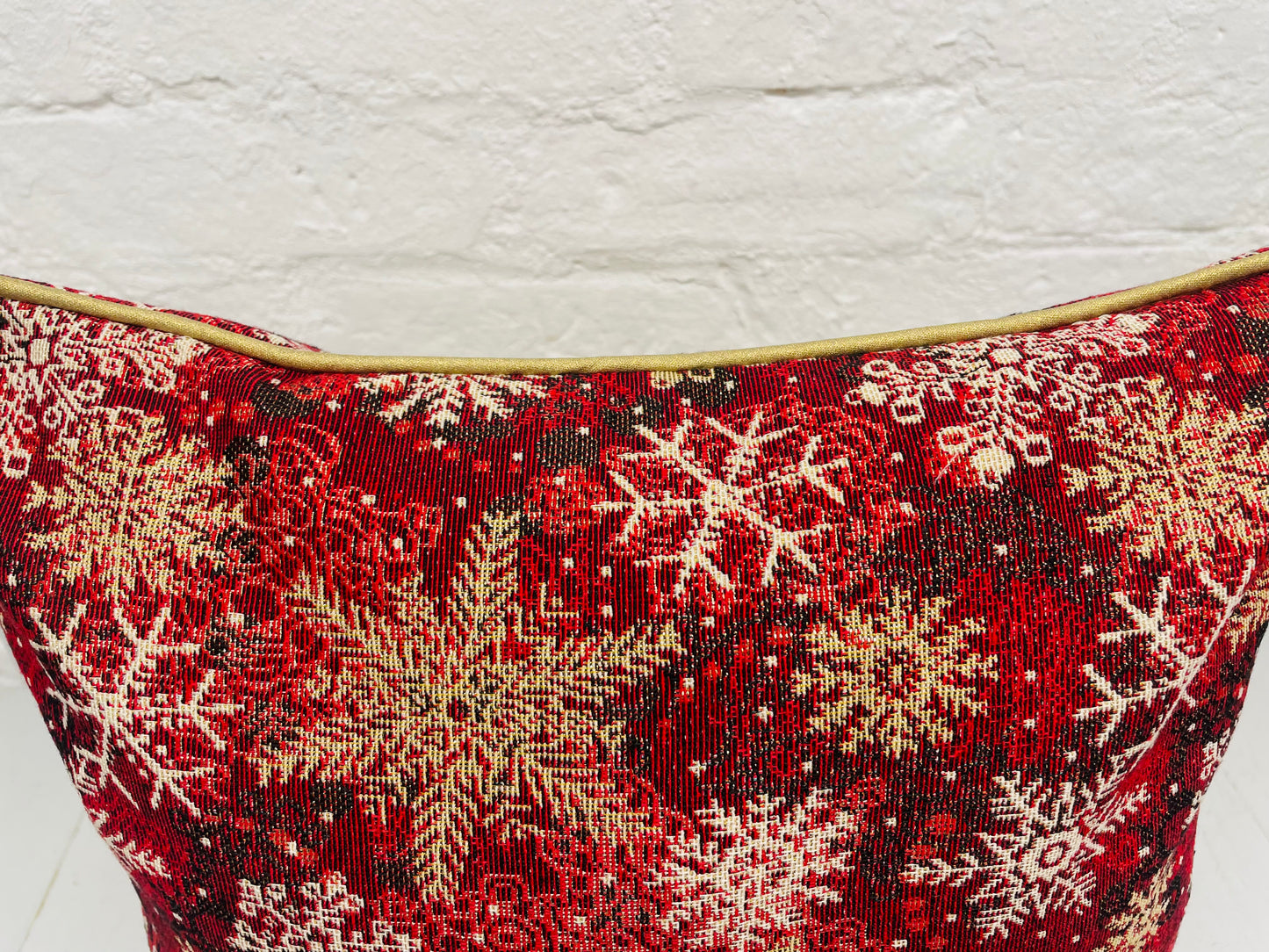 Snowflake Cushion with gold piping.