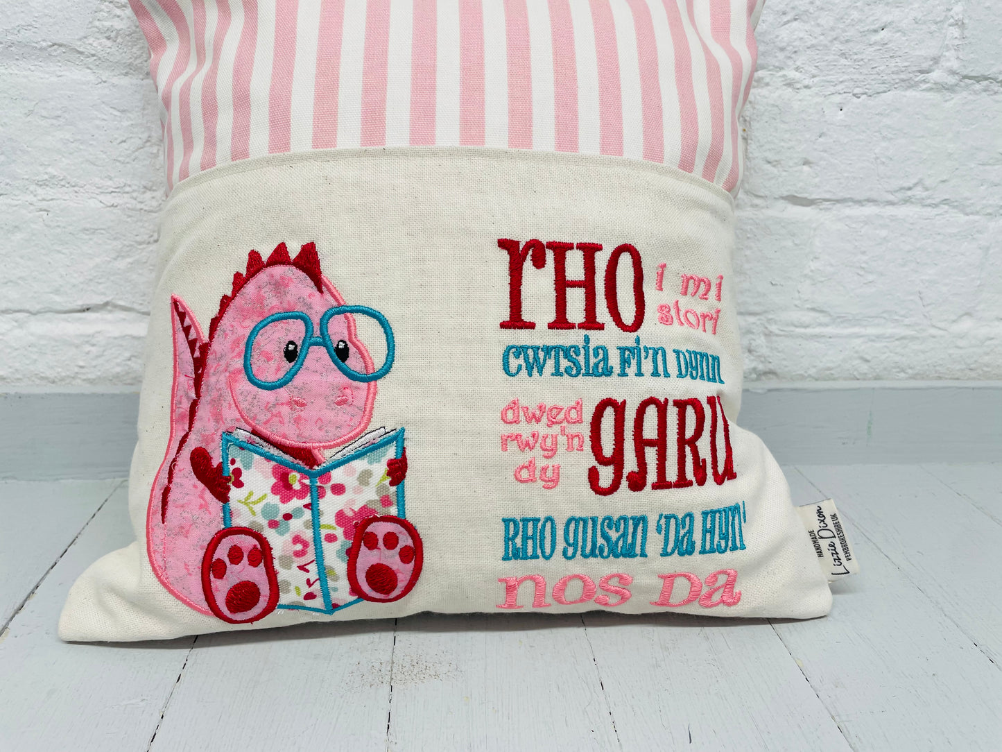 Welsh Pink Dino Children's Reading Book Cushion.