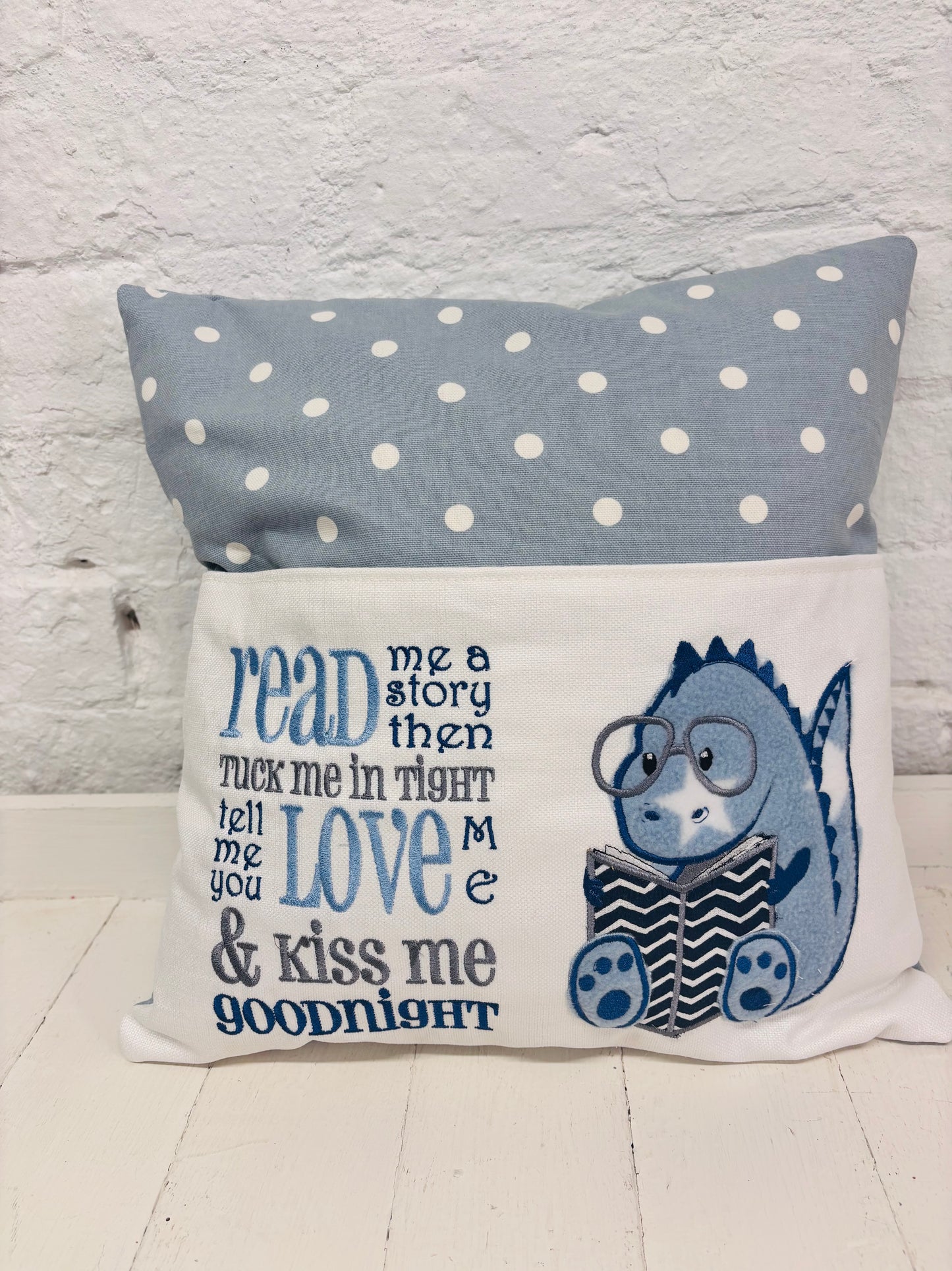 Blue Dino children’s Book Cushion available in Welsh or English.