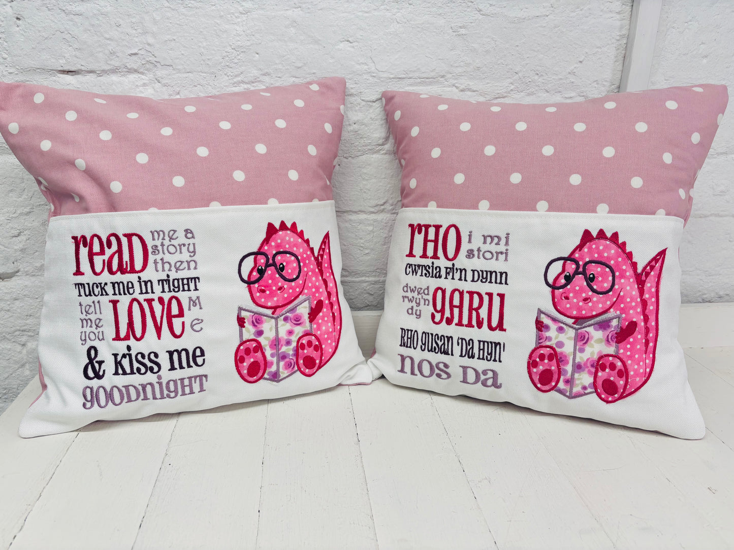 Pink Dino Children's Reading Book Cushion. available in Welsh and English