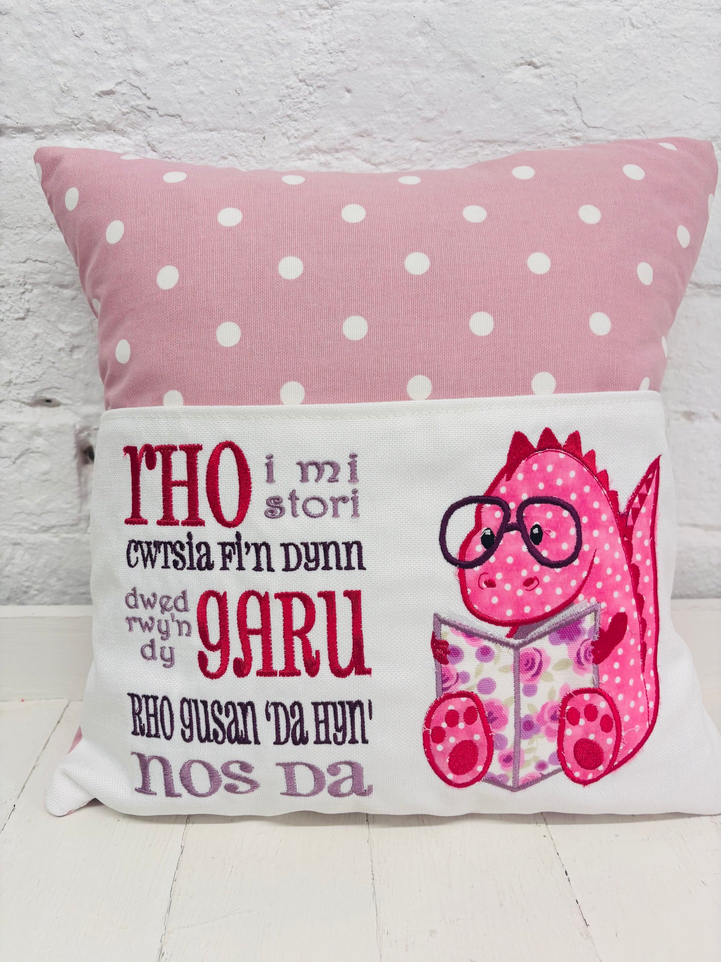 Pink Dino Children's Reading Book Cushion. available in Welsh and English