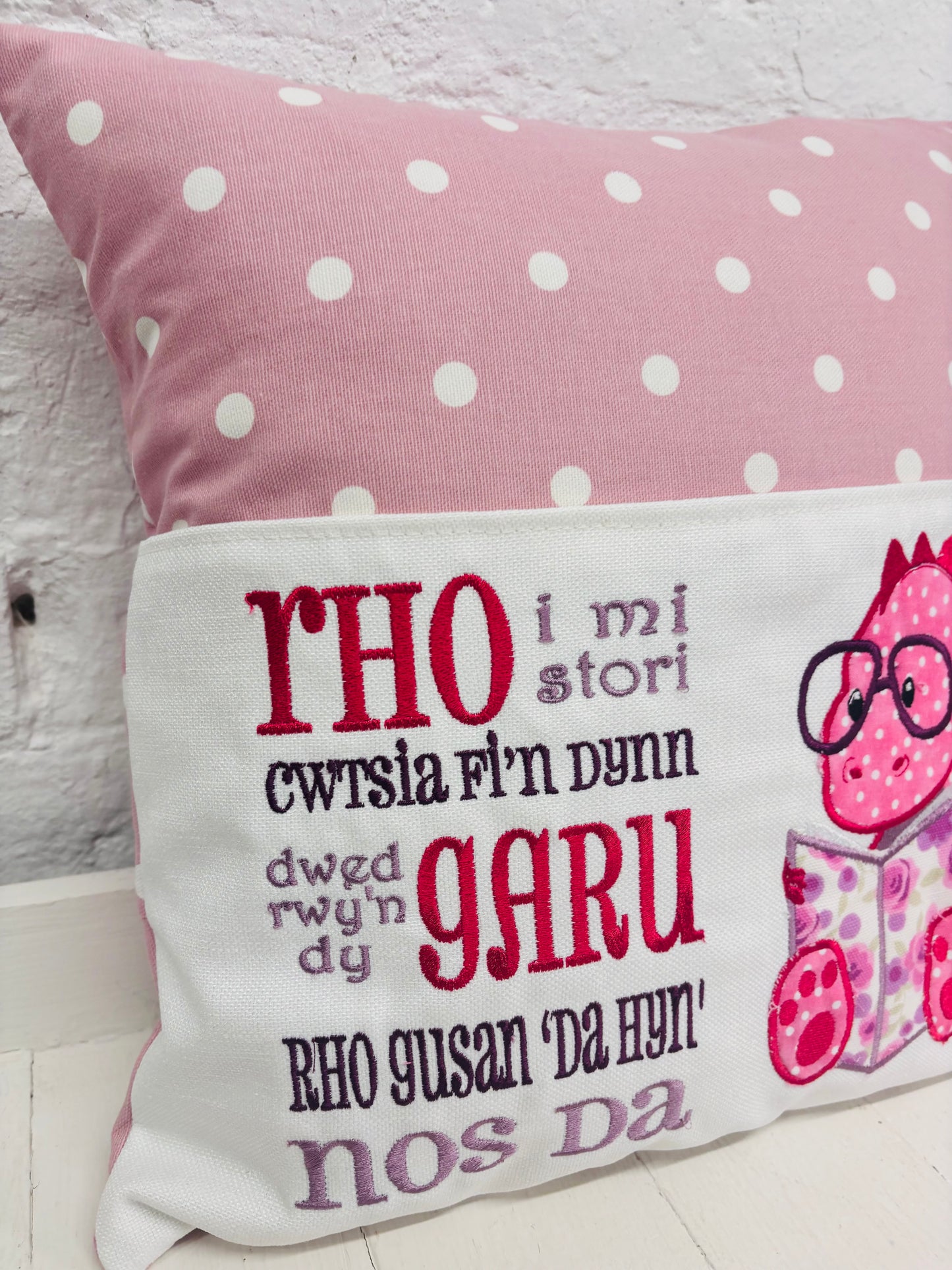 Pink Dino Children's Reading Book Cushion. available in Welsh and English