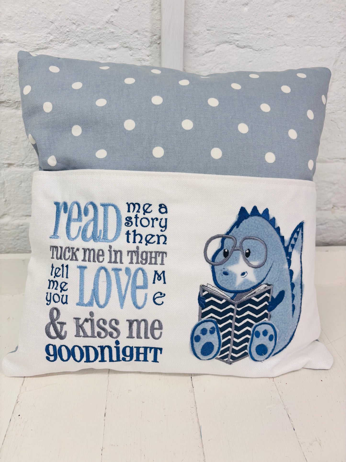 Blue Dino children’s Book Cushion available in Welsh or English.