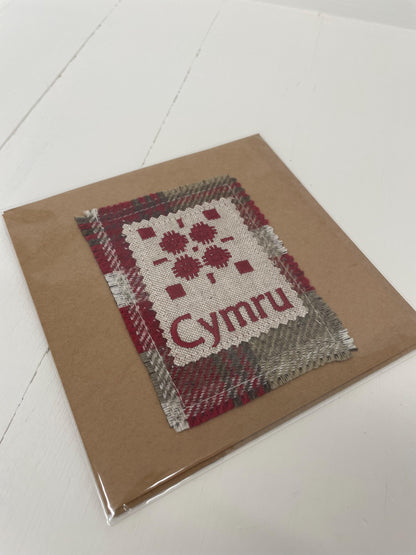 Handmade Card with machine embroidered Welsh blanket design & Cymru on Red Wool fabric square mounted on a Kraft card with envelope