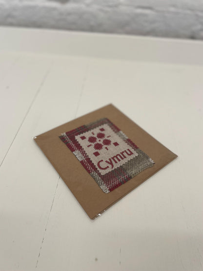 Handmade Card with machine embroidered Welsh blanket design & Cymru on Red Wool fabric square mounted on a Kraft card with envelope
