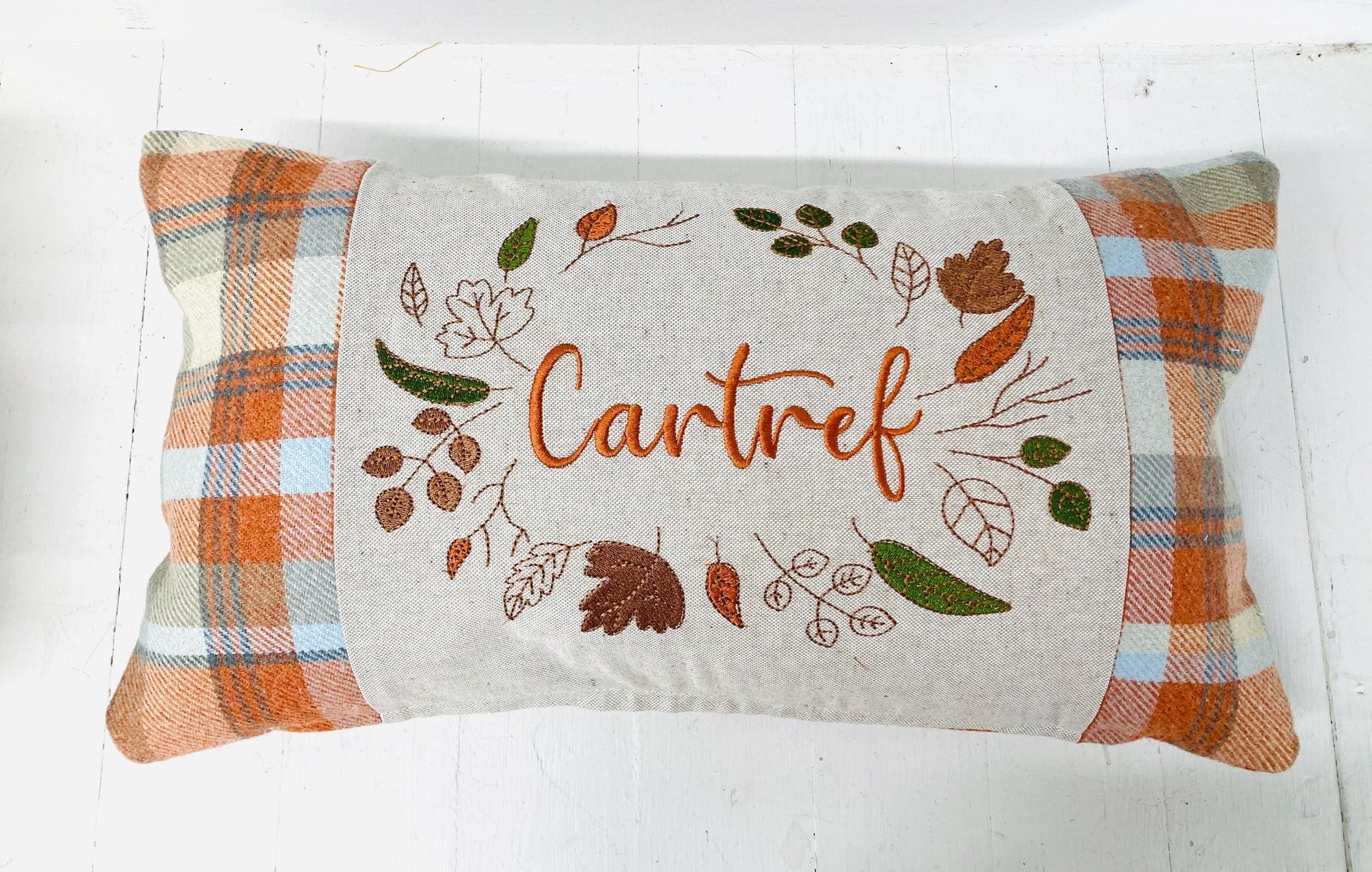 Orange Tartan Cushion with Cartref(Welsh for Home) panel adorned with embroidered leaves.