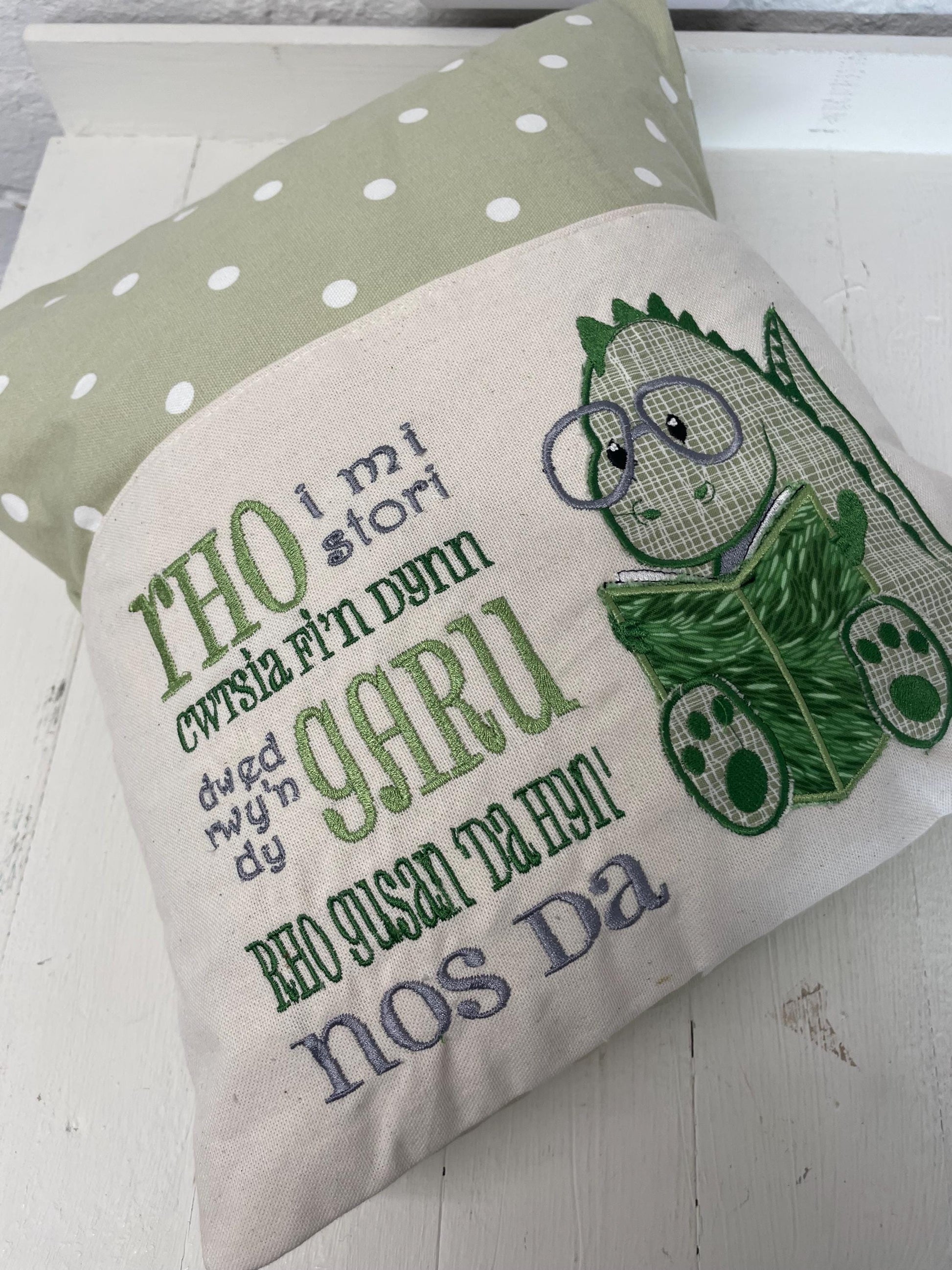 Cute dinosaur Children's Book Cushion available in Welsh and English