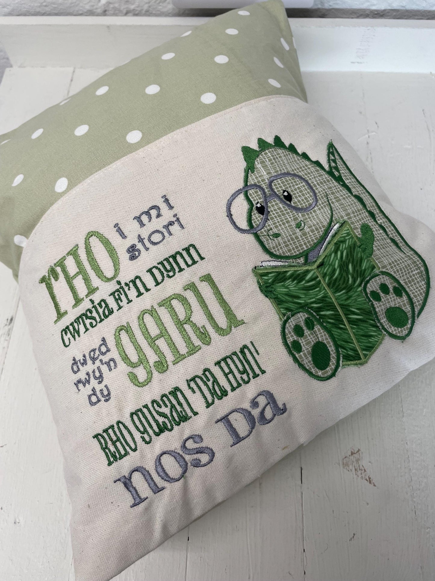 Cute dinosaur Children's Book Cushion available in Welsh and English