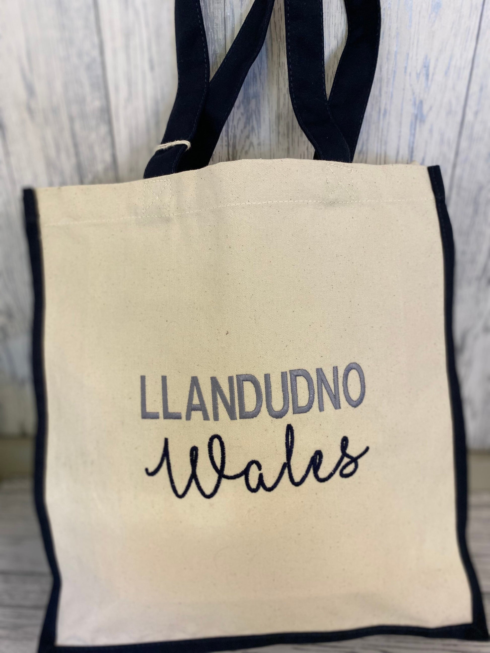 Location shopper tote bag Llandudno Wales large canvas shopper cream with navy blue sides and handles and embroidered lettering