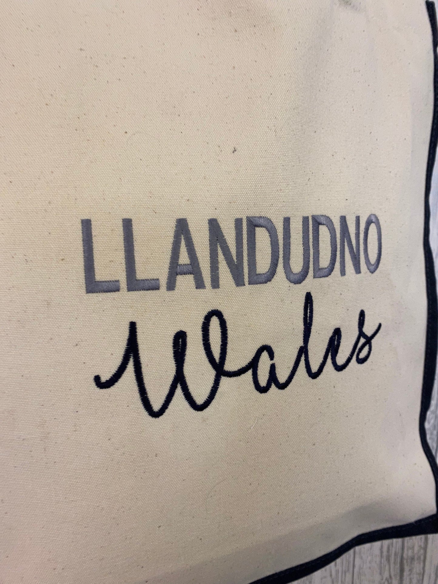 Location shopper tote bag Llandudno Wales large canvas shopper cream with navy blue sides and handles and embroidered lettering